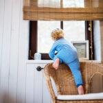 Child-climbing-window-scaled-1-1024x722