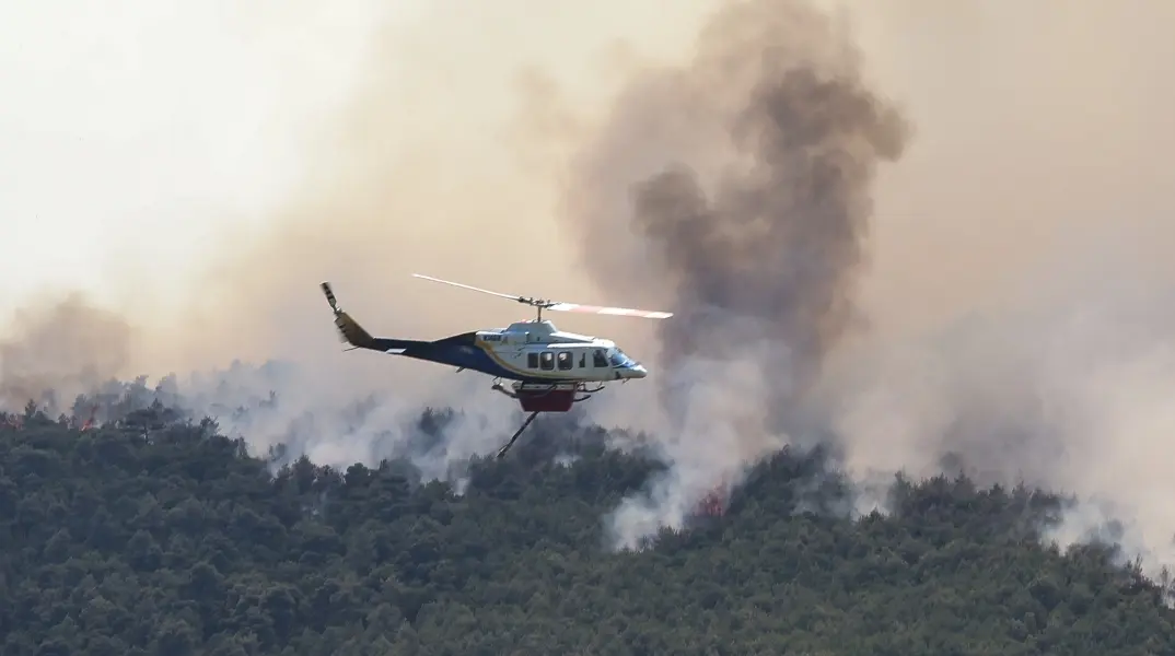Bell 214 σε επιχείρηση αεροπυρόσβεσης Bell 214 σε επιχείρηση αεροπυρόσβεσης πάνω από δασική πυρκαγιά